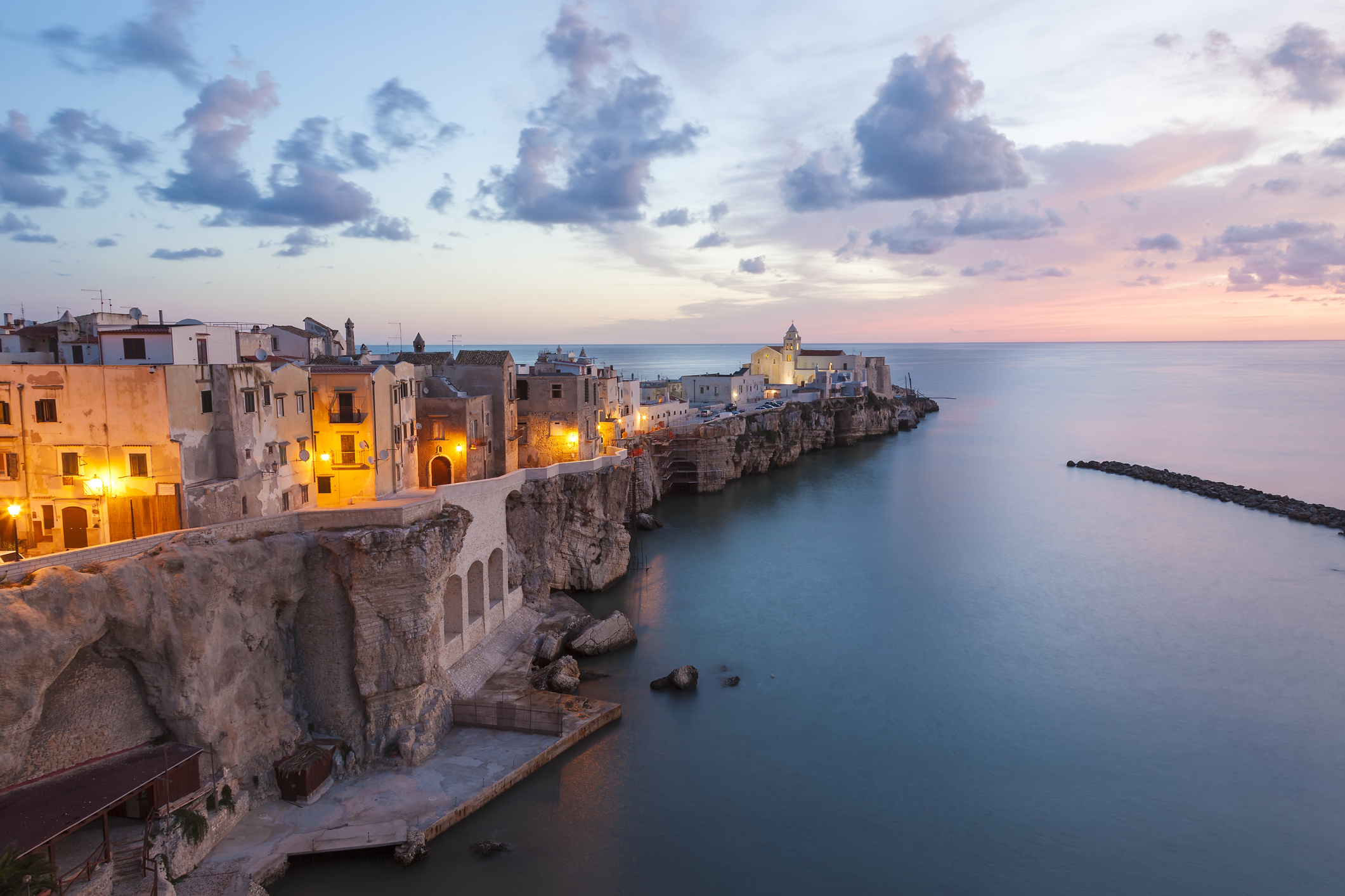 High angle view of traditional houses build on a cliff on the Mediterranean Sea at sunset.